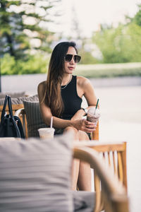 Young woman sitting on table