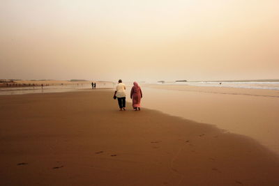 Rear view of women on beach