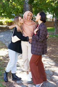 Friends standing together in park