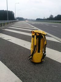 Yellow umbrella on road