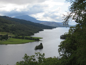 Scenic view of lake against cloudy sky