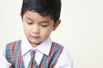 Portrait of cute boy against white background