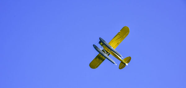 Low angle view of airplane against clear sky