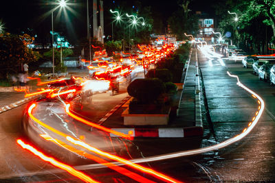 Digital composite image of light trails on road at night