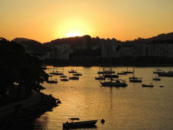 Boats in marina at sunset