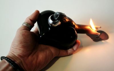 Close-up of hand holding candle