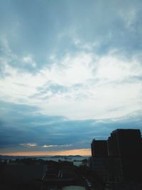 Low angle view of buildings against sky at sunset