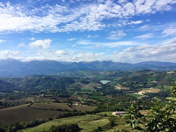 Scenic view of mountains against cloudy sky