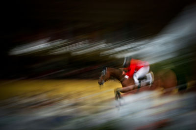 Blurred motion of man riding motorcycle