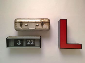 Red letter l and retro briefcase mounted on wall