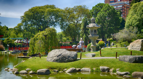 Statues in garden against sky