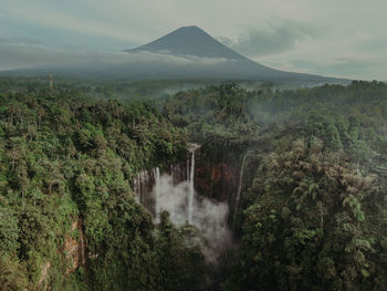 Scenic view of waterfall against sky