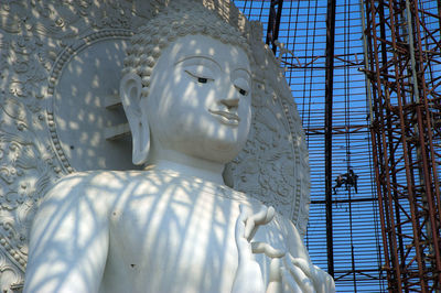 Low angle view of statue against white building