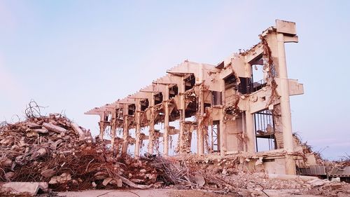 Low angle view of damaged building against clear sky