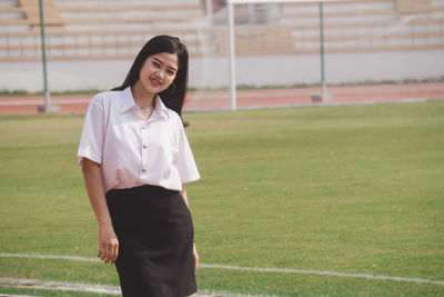 Portrait of a smiling young woman standing outdoors