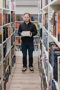 Portrait of woman standing in library