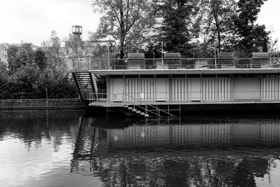 Built structure by lake against sky