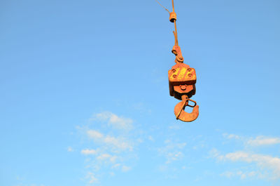 Low angle view of toys against blue sky