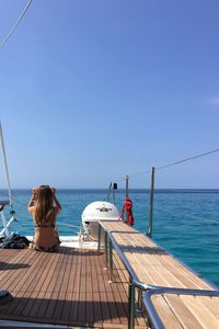 People relaxing at swimming pool against sky
