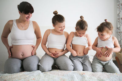 Pregnant mother with 3 daughters, a lifestyle in a real interior. the concept of a large family 