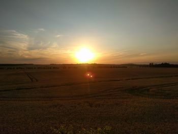 Scenic view of field against sky during sunset