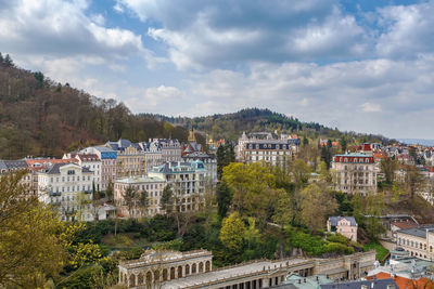 High angle view of buildings in town against sky