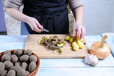 High angle view of woman preparing food on cutting board