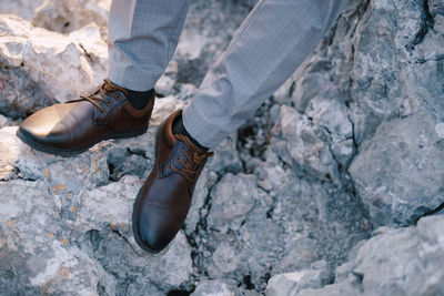 Low section of person standing on rock