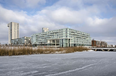 Residential buildings and canal in winter