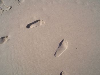 High angle view of footprints on sand