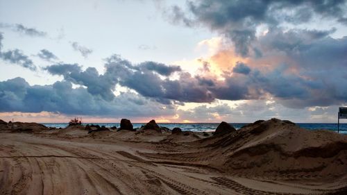 Panoramic view of desert against sky during sunset