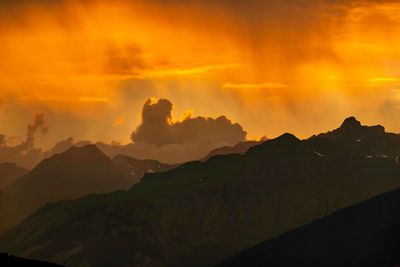 Scenic view of silhouette mountains against sky during sunset