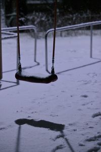 Snow covered swing at playground