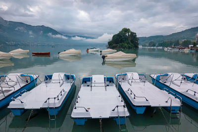 Boats moored in sea against sky