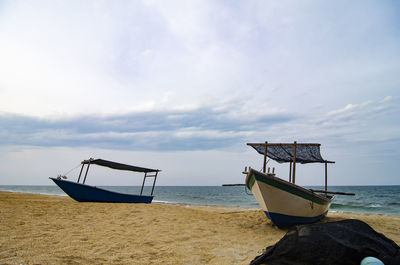 Boats on beach against sky