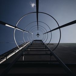 Low angle view of airplane flying against sky