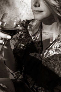 Midsection of a woman drinking glass