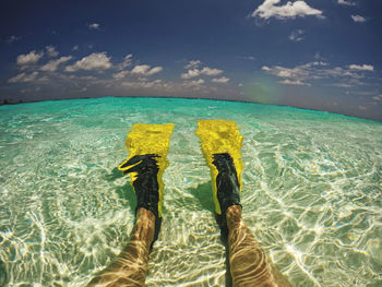 Low section of woman swimming in sea