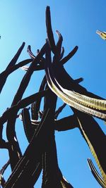 Low angle view of metallic structure against blue sky