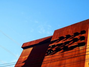 Low angle view of building against clear blue sky