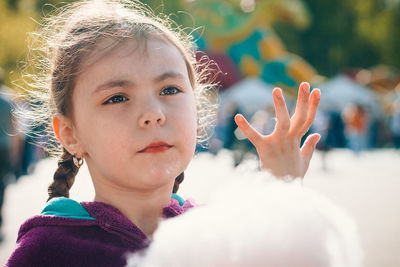 Close-up of cute girl with cotton candy