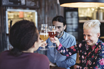 Rear view of people enjoying in drinking glass