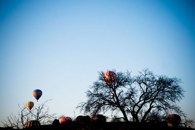 Low angle view of hot air balloon against clear blue sky