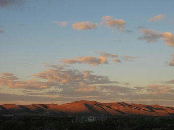 Houses against sky during sunset