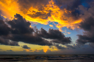 Scenic view of dramatic sky over sea during sunset