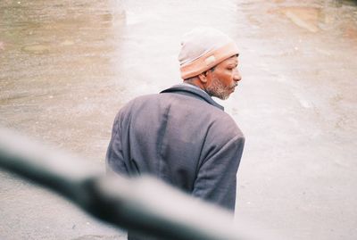 Midsection of man standing on rock