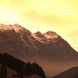 Scenic view of mountains against cloudy sky