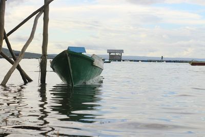 Boat moored in sea against sky