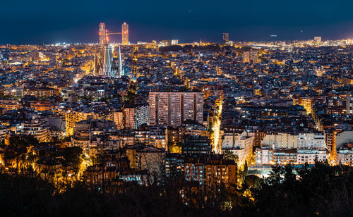 High angle view of city lit up at night