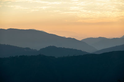 Scenic view of silhouette mountains against sky during sunset